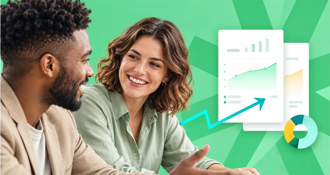 Two colleagues smiling while reviewing growth dashboards